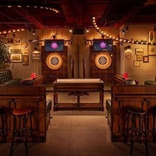 A bar interior with drinks and patrons during happy hour.