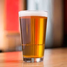 A full pint of ale in a beer glass