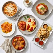 Several pasta dishes served in an Italian trattoria