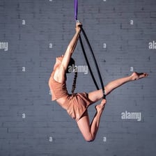 A circus acrobat performing an aerial maneuver.