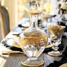 A glass carafe filled with wine on a dining table
