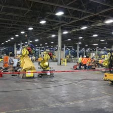 Industrial machinery being modified or retooled in a factory
