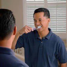 A toothbrush being used to clean teeth.