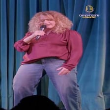 A comedian performing a humorous gag before an audience.