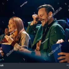 A person laughing during an entertaining performance