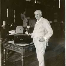 A portrait of Thomas Alva Edison alongside examples of his inventions.
