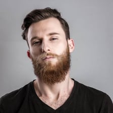 A person wearing a visibly self-satisfied expression.