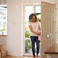 A person coming back home through a front door.