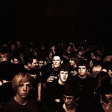 A person recognizing another individual in a crowd.