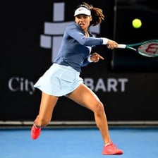 Emma Raducanu playing tennis in a match