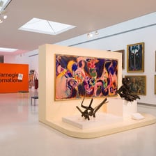 Paintings displayed in an art gallery.