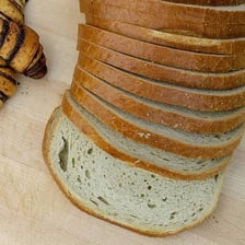 A loaf of rye bread sliced for deli sandwiches.