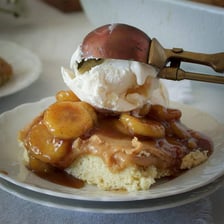 A serving of Bananas Foster with sautéed bananas and vanilla ice cream.