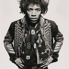 Jimi Hendrix shown with his characteristic rounded afro hairstyle