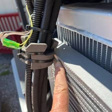 A garden hose caught and torn on a sharp edge.