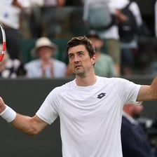 A tennis player celebrating after winning a match.
