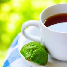 Cup of Earl Grey tea beside loose tea leaves