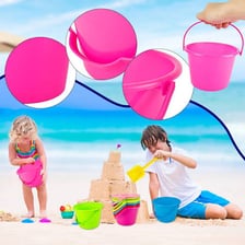 A small colorful pail on a sandy beach.