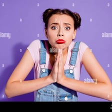 A person making an earnest plea with clasped hands.