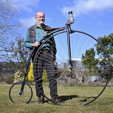 A person rotating a large wheel.