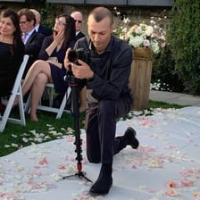 A videographer recording a wedding ceremony.