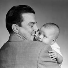A father holding a baby