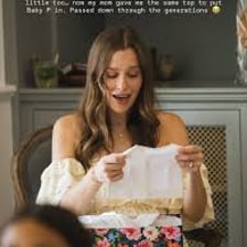 A person admiring a lovely gift with an appreciative expression.