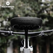 A close-up view of a bicycle seat mounted above the rear wheel.