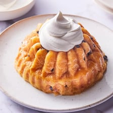 A baba au rhum cake soaked in rum syrup and served as a dessert.