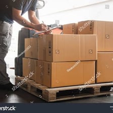 Boxes being stacked into a large stockpile.