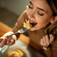 Person eating a substantial meal