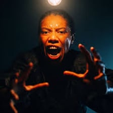 A person startling another person with a shouted scare