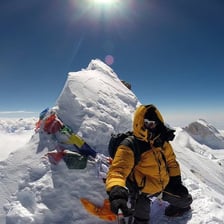 A mountain summit viewed above the surrounding landscape