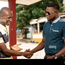 Two male friends greeting each other