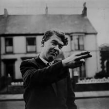 A portrait of British writer Kingsley Amis.