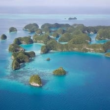 A small island surrounded by water among other islands