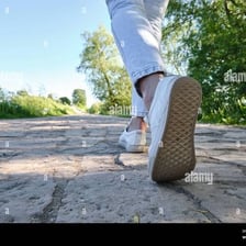 A person traveling on foot along a road.