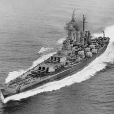 A gray battleship sailing at sea