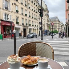 Outdoor tables at a traditional Parisian sidewalk café.