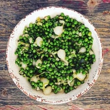A bowl of small green peas representing petits pois.