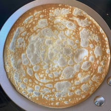 A thin French crêpe folded on a plate