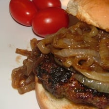 Slices of sweet onion served on top of a hamburger.