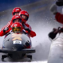 A luge sled racing on an icy track.