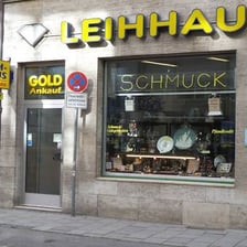 A customer presenting an item at a pawnbroker’s counter