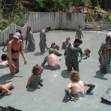 A spa guest receiving a mud bath treatment.