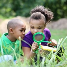 A child moving quickly across a grassy field