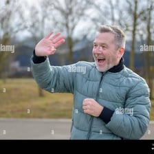 A person waving to greet another person