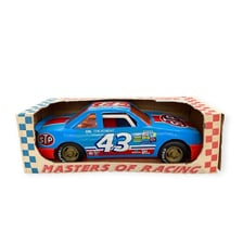 A vintage NASCAR race car bearing STP branding.