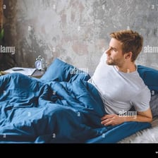 A person stirring awake in bed.
