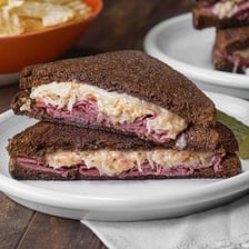 A Reuben sandwich served on slices of rye bread.
